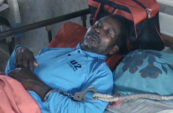  Charan Soren, one of the victims in November 6 attack on his village in Gaibandha, was spotted lying in a hospital bed in handcuff Dhaka Tribune